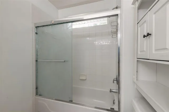 an empty room with chandelier fan