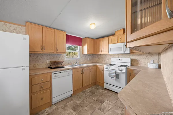 a kitchen with a white cabinets and white appliances
