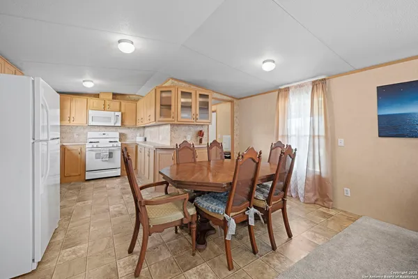 a view of a dining room with furniture and a window