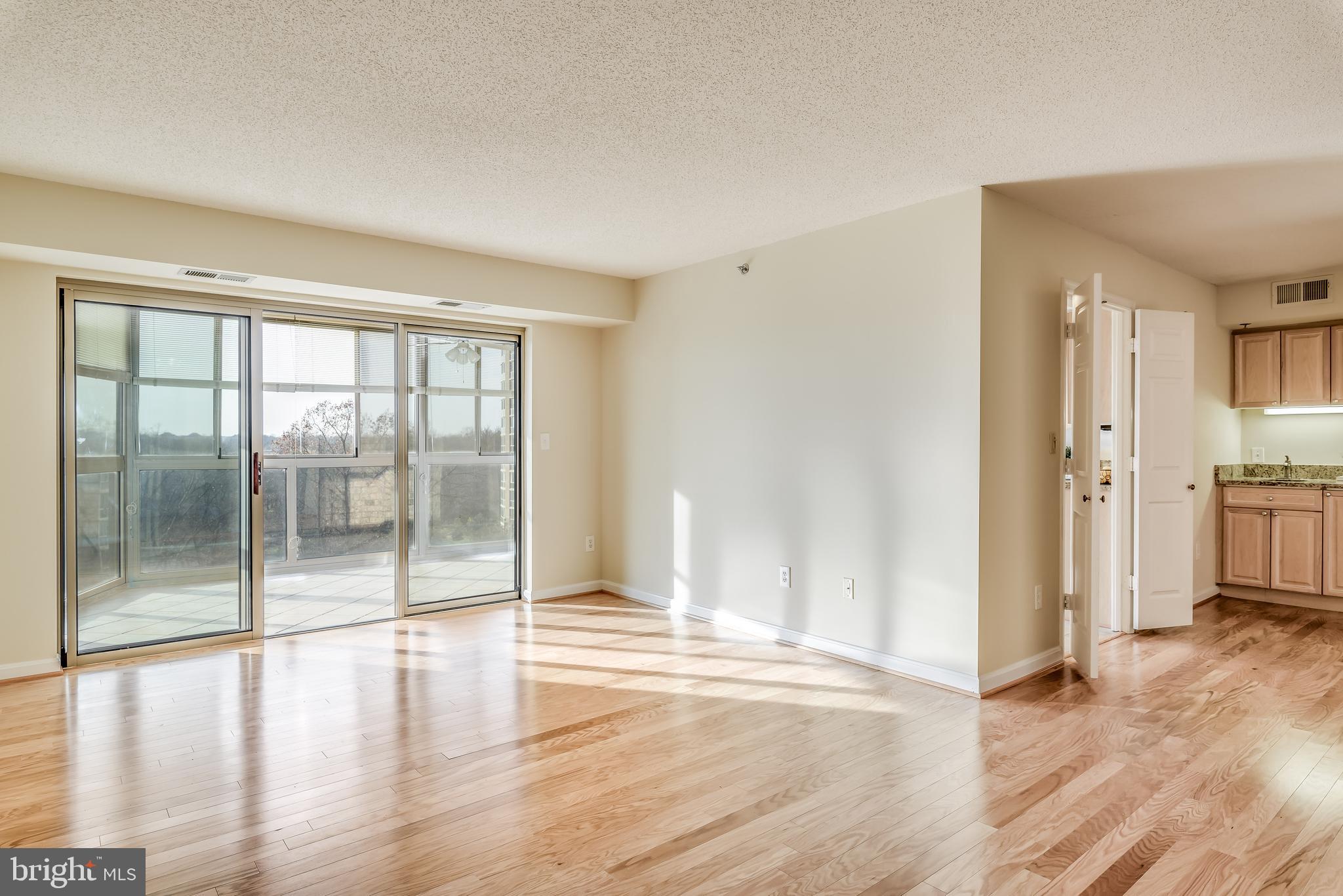 19385 Cypress Ridge Terrace, Unit 801 Leesburg, VA 20176 - Photo 1 of 21 Pristine wood floors lead to sun room balcony