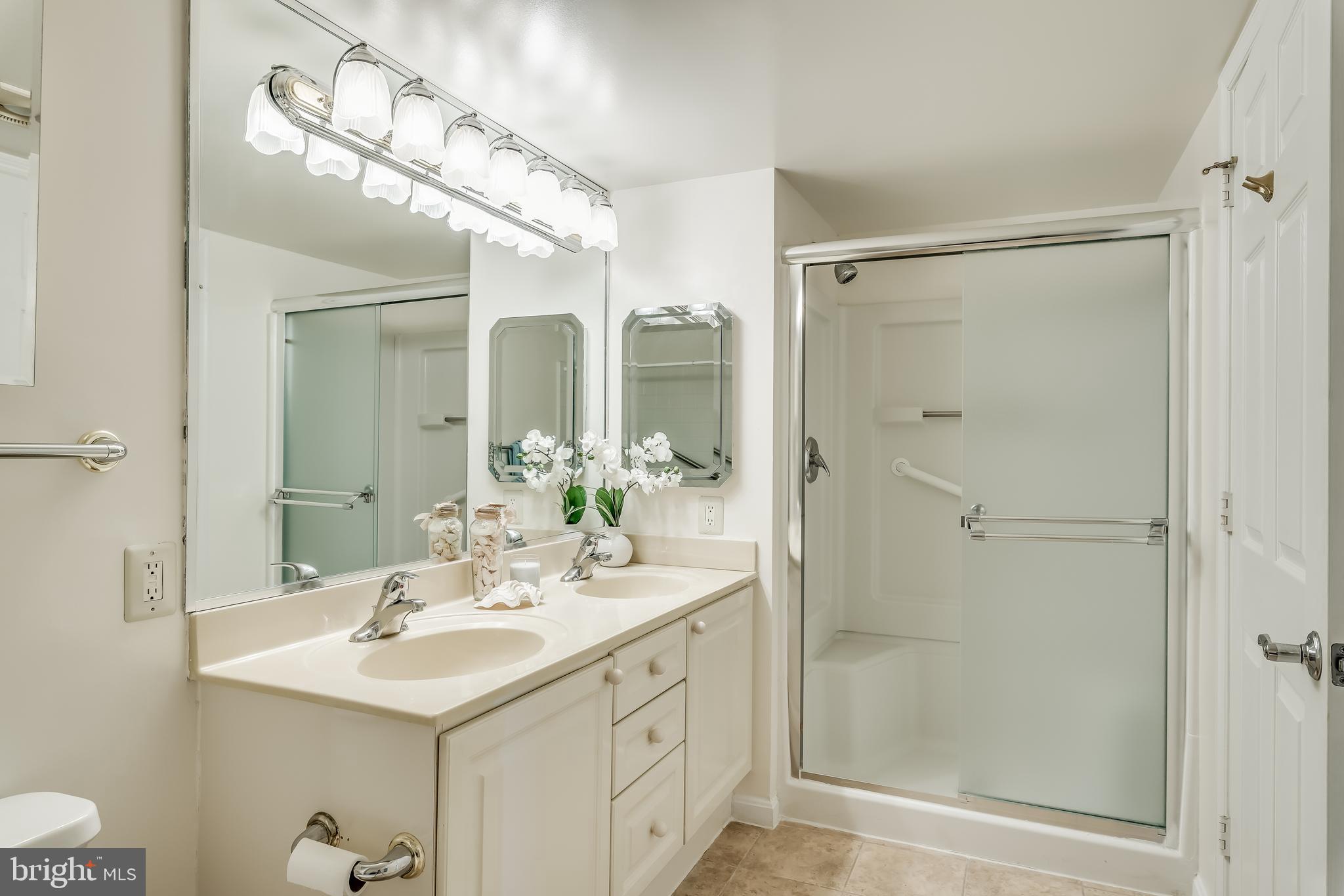 19385 Cypress Ridge Terrace, Unit 801 Leesburg, VA 20176 - Photo 15 of 21 Master bathroom hosts a tub and a shower