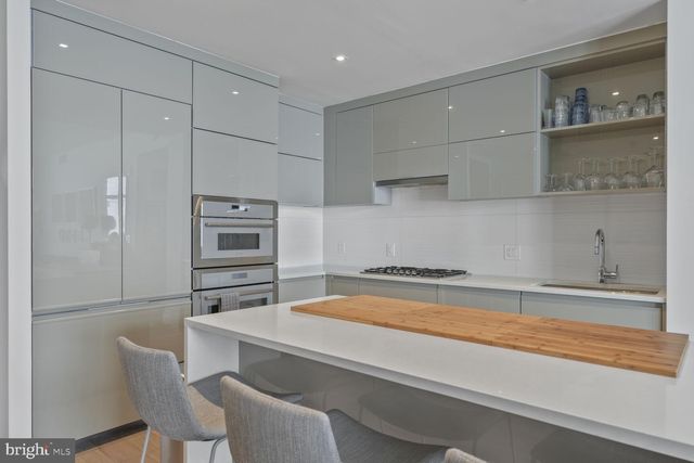 a kitchen with stainless steel appliances a refrigerator and cabinets