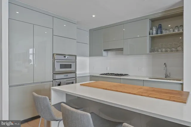a kitchen with stainless steel appliances a refrigerator and cabinets