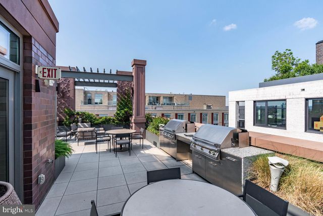a outdoor space with patio the couches and a fireplace
