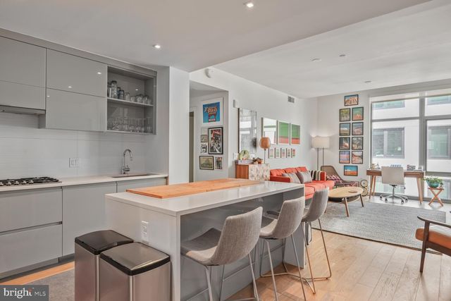 a room with stainless steel appliances kitchen island granite countertop furniture and a kitchen view