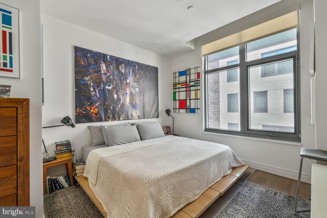 a bedroom with a large bed and a window