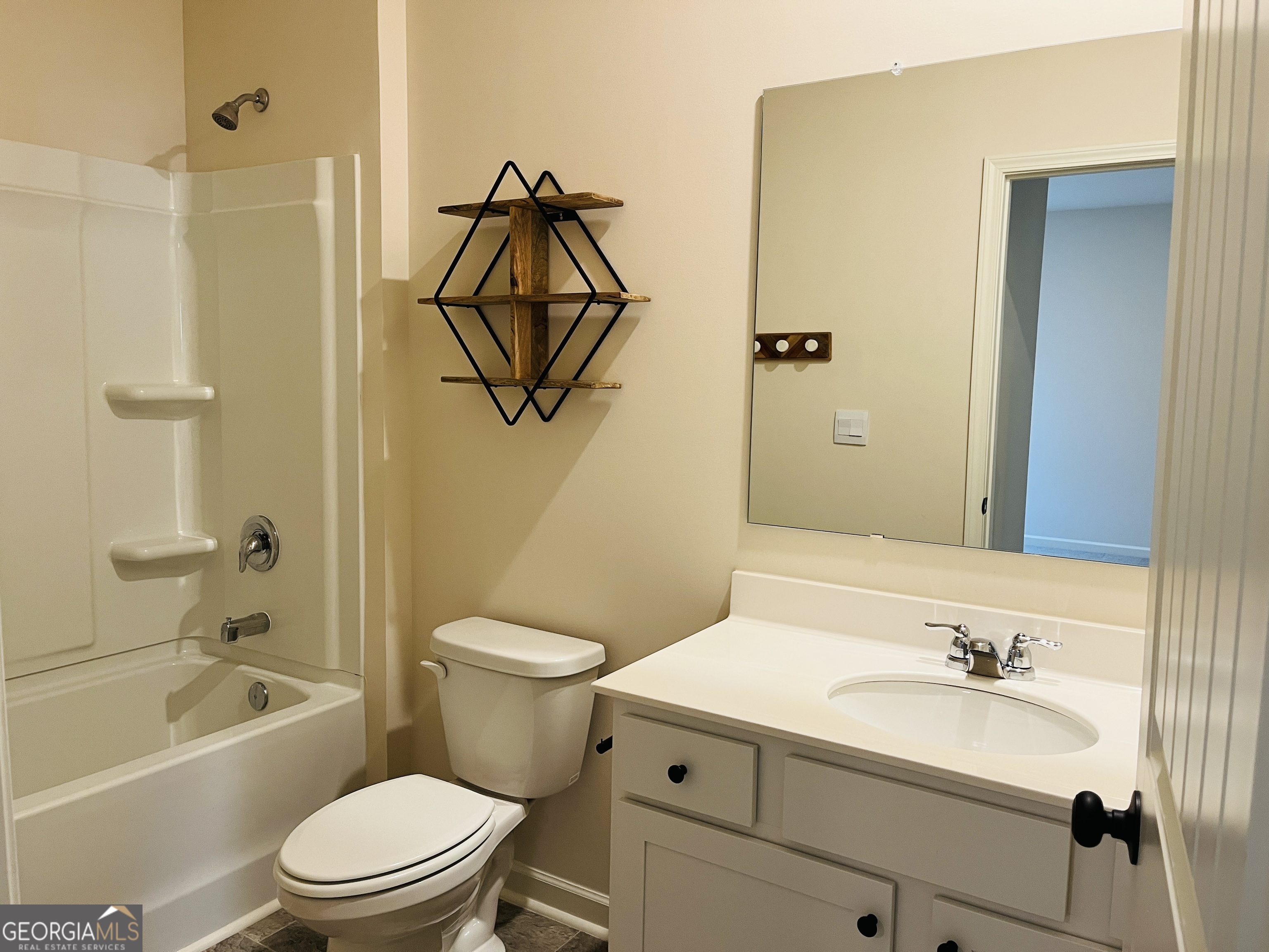 910 Sly Fox Run Fairburn, GA 30213 - Photo 18 of 46 a bathroom with a sink a toilet and shower