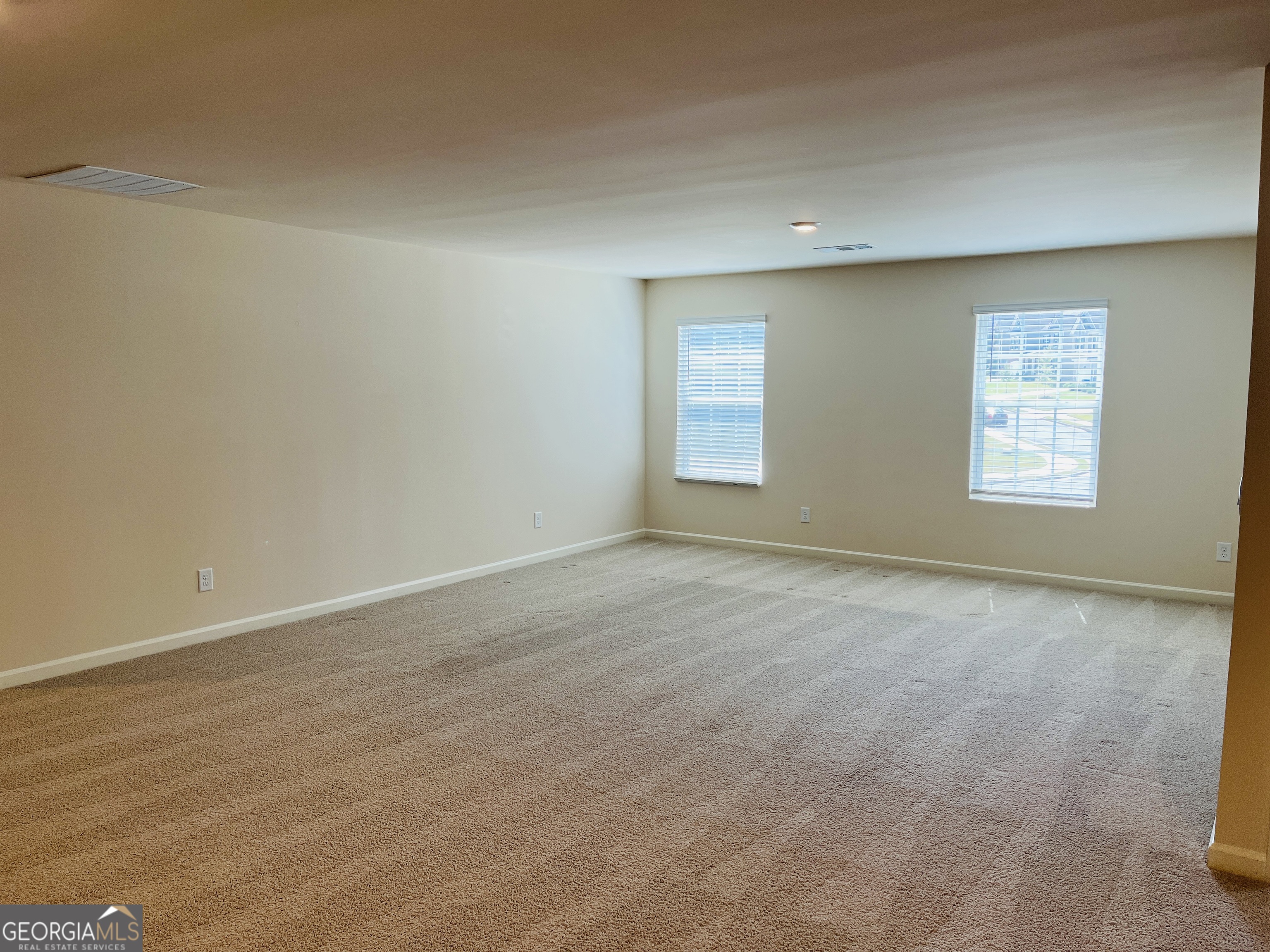 910 Sly Fox Run Fairburn, GA 30213 - Photo 20 of 46 an empty room with windows