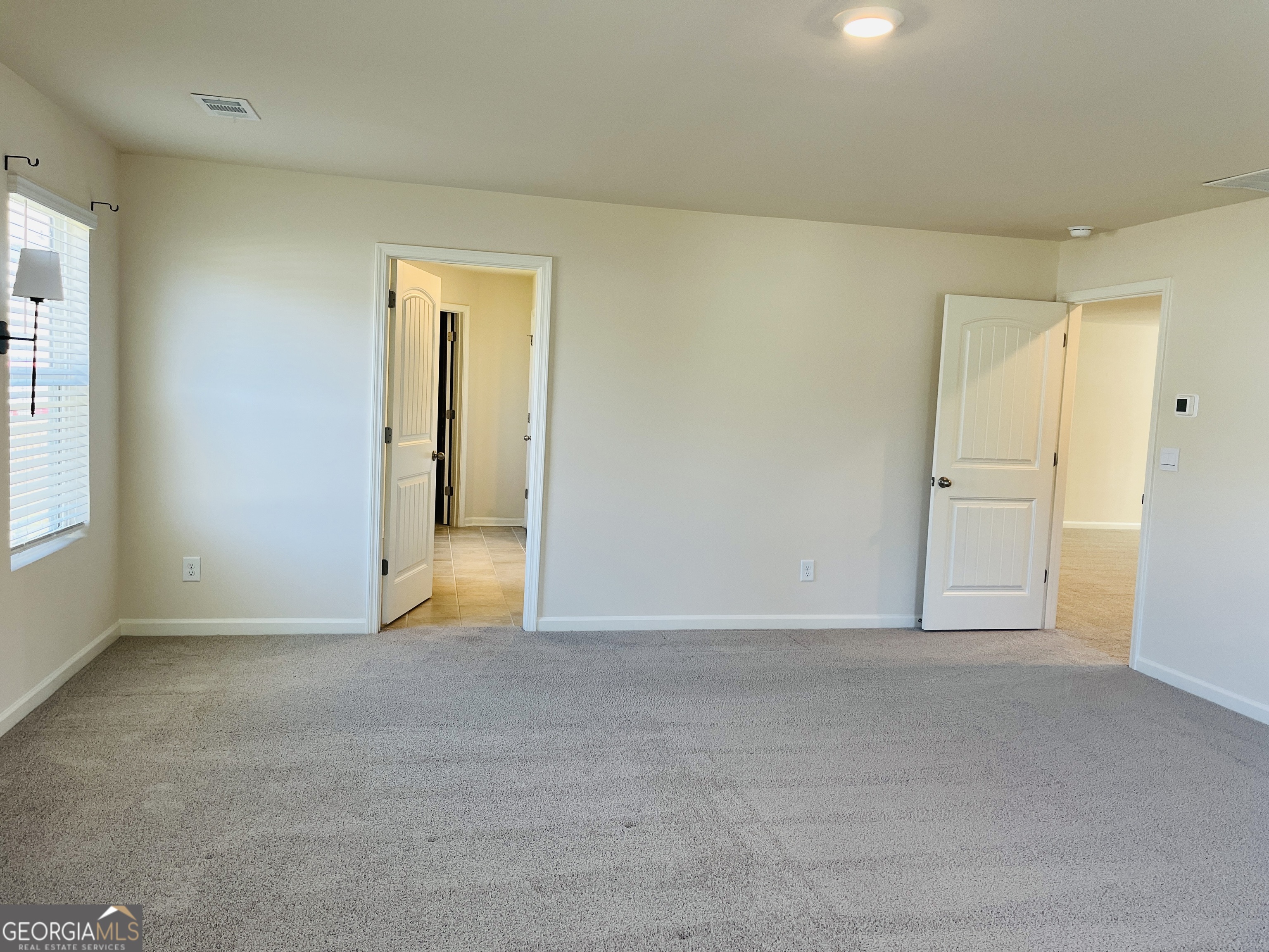 910 Sly Fox Run Fairburn, GA 30213 - Photo 32 of 46 a view of an empty room and window