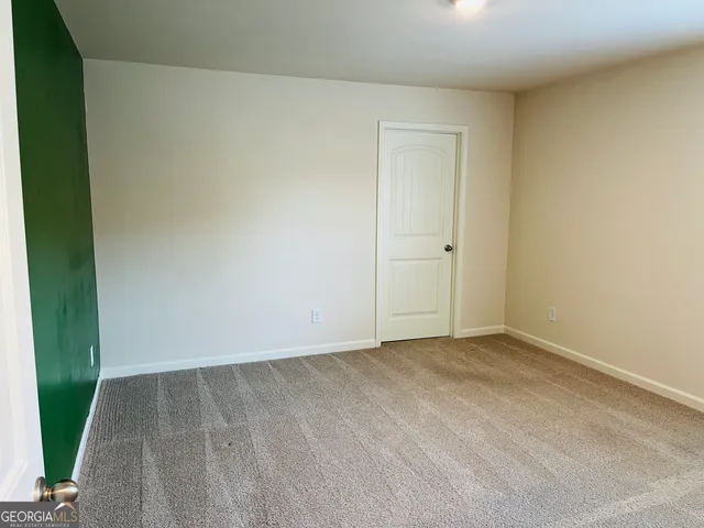 an empty room with wooden floor
