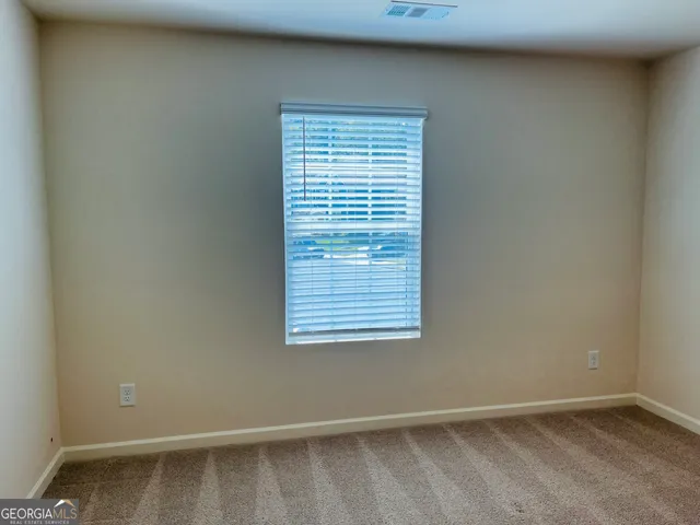 an empty room with closet area