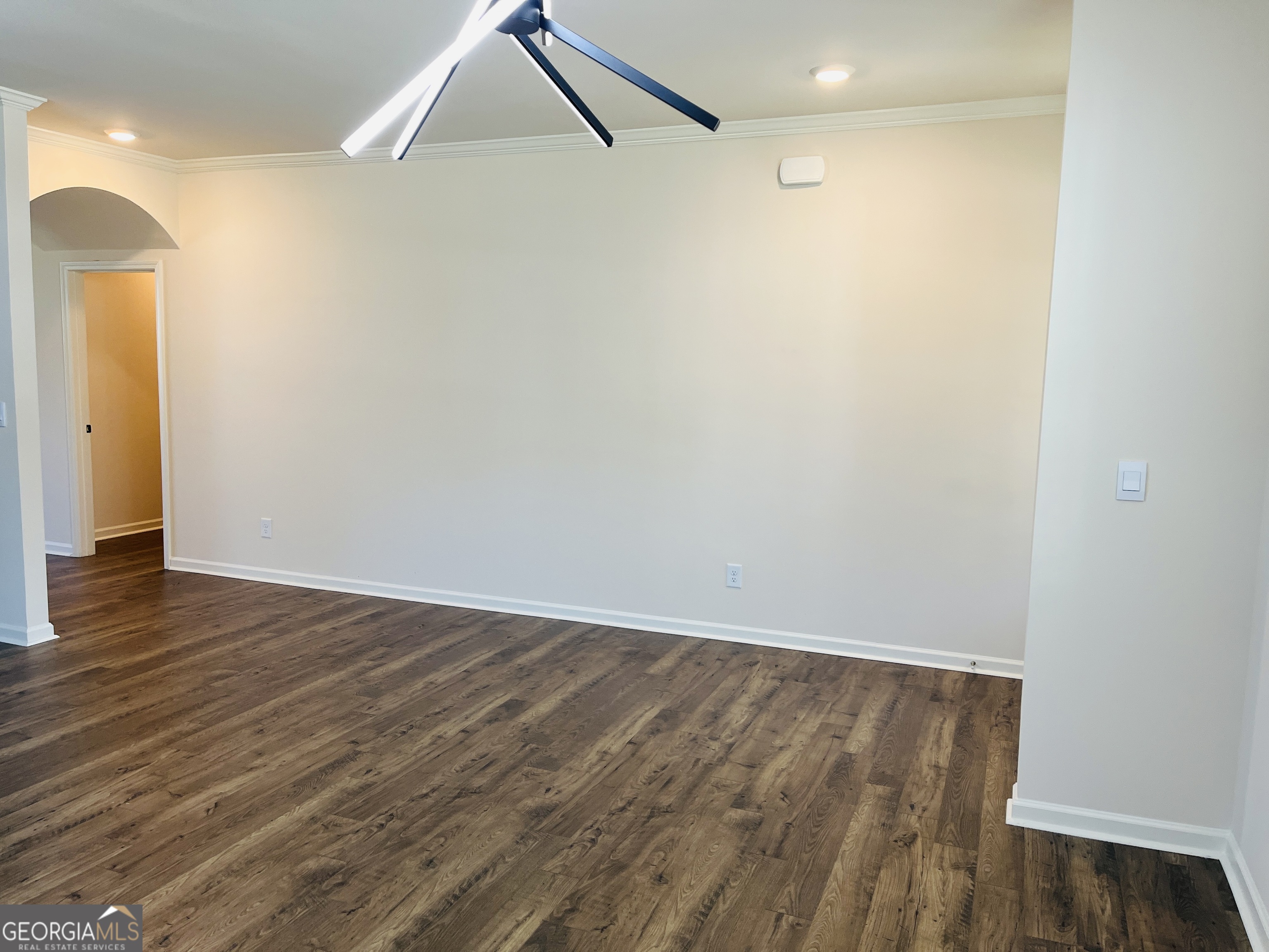 910 Sly Fox Run Fairburn, GA 30213 - Photo 5 of 46 a view of an empty room with wooden floor and a ceiling fan