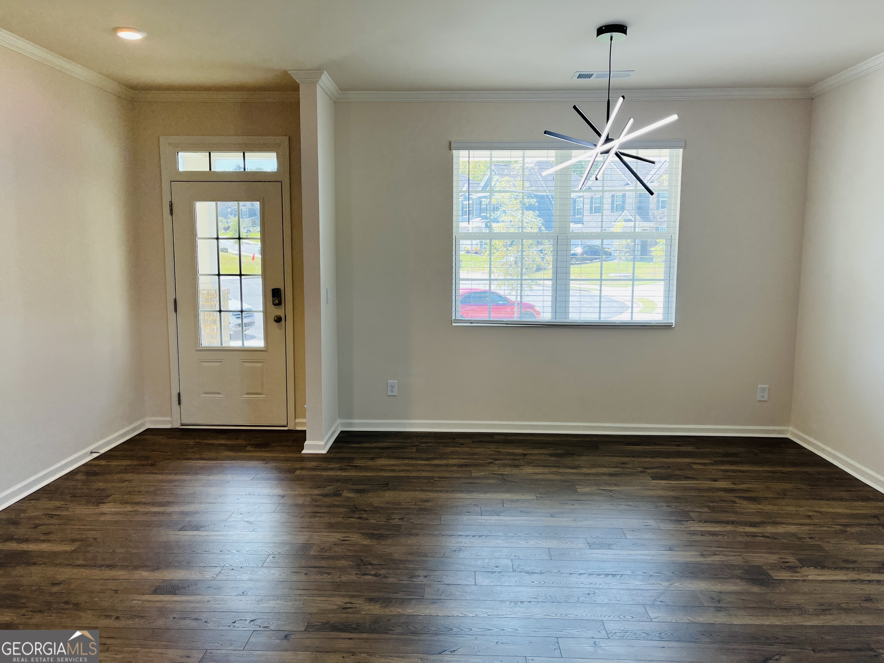 910 Sly Fox Run Fairburn, GA 30213 - Photo 6 of 46 a view of an empty room with wooden floor and a window