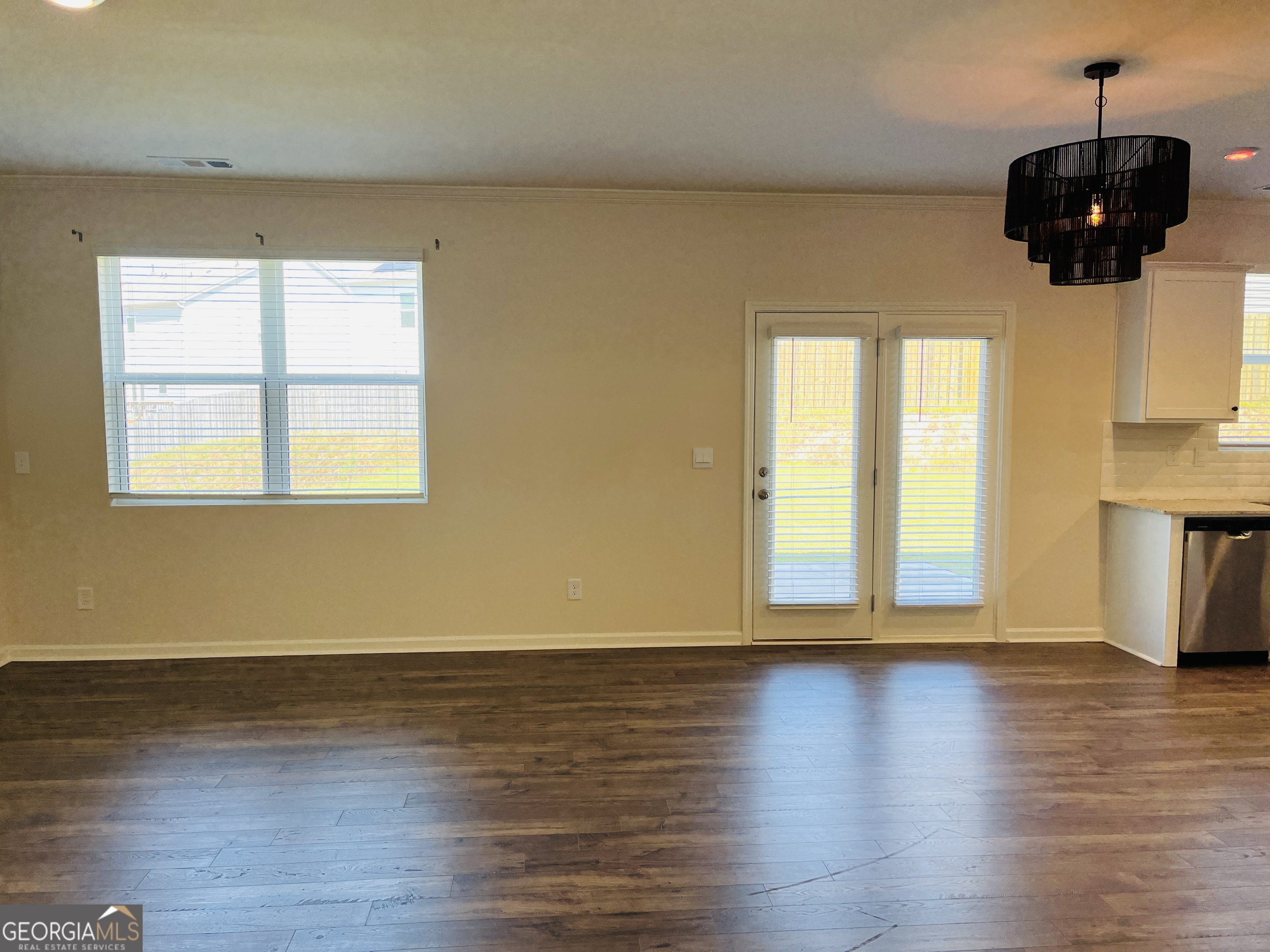910 Sly Fox Run Fairburn, GA 30213 - Photo 7 of 46 a view of an empty room with wooden floor and a window