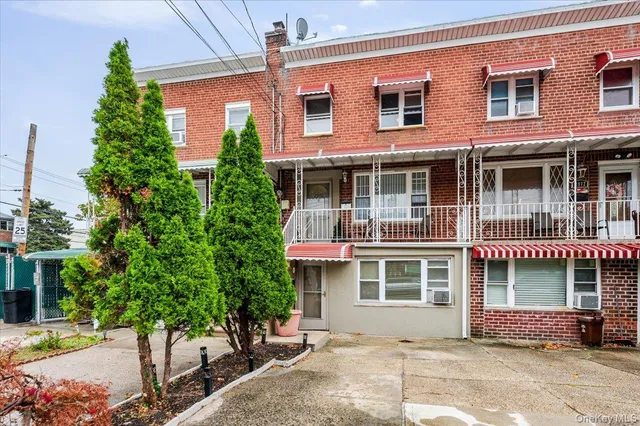a front view of a building with trees