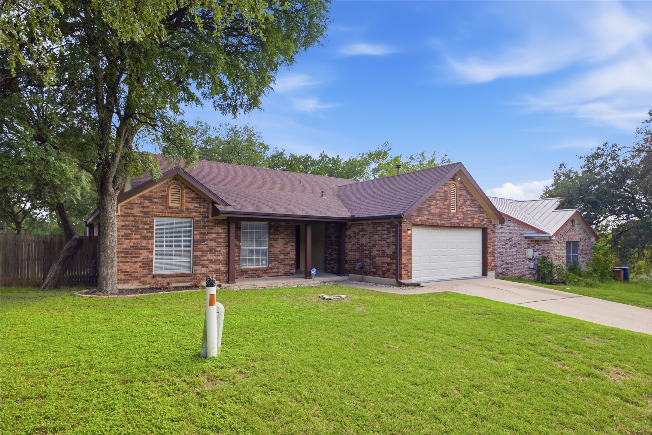 2922 Wickersham Lane Austin, TX 78741 - Photo 2 of 26 a front view of a house with a yard and garage