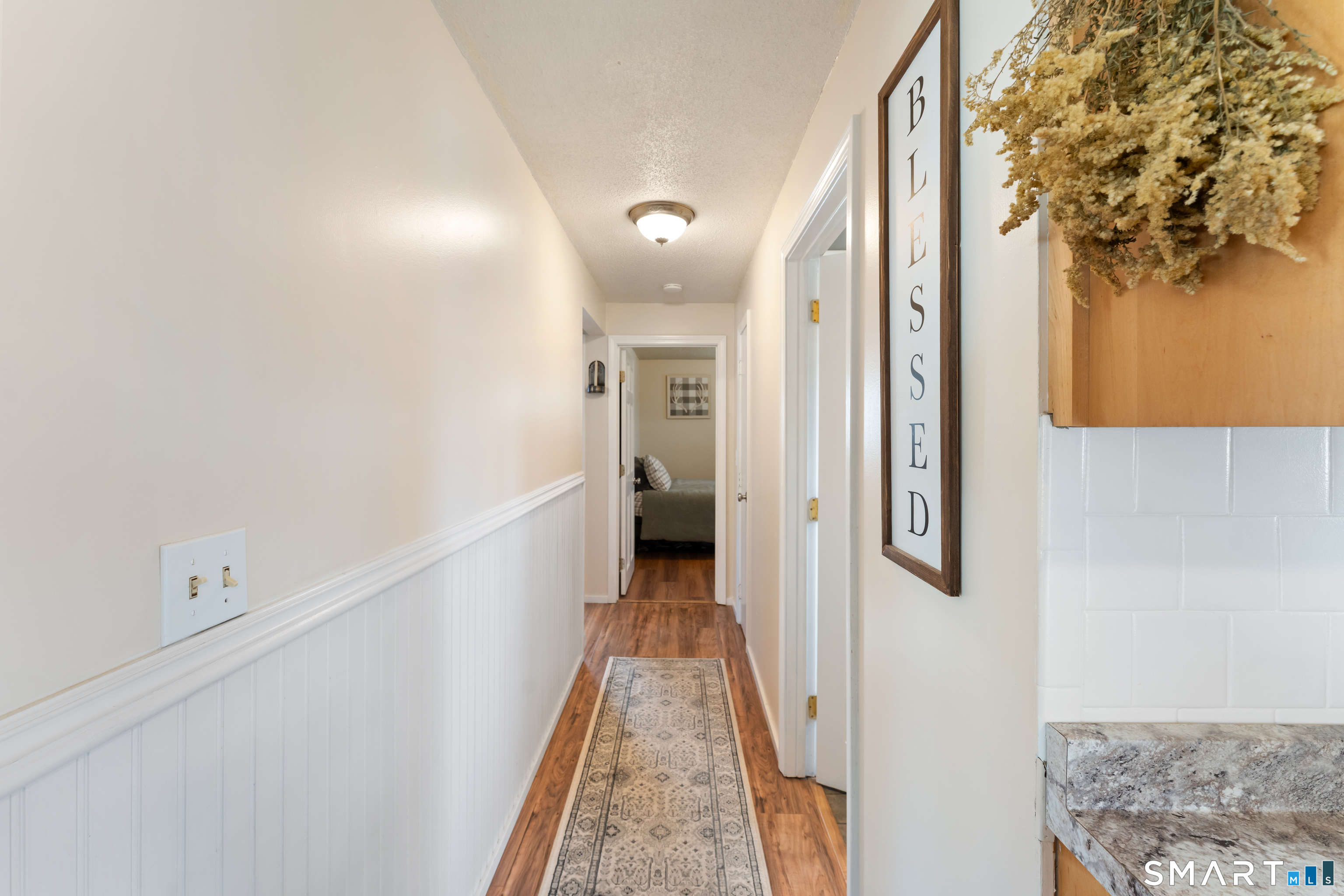 14 Liberty Lane Thompson, CT 06277 - Photo 24 of 39 a view of a hallway with wooden floor and staircase