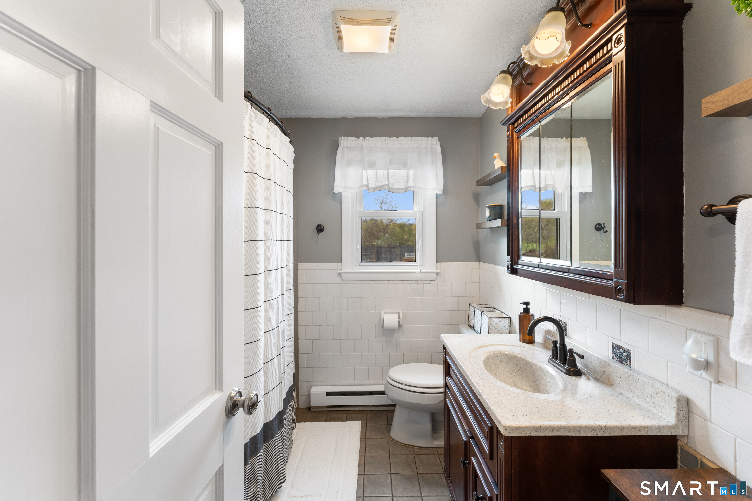 14 Liberty Lane Thompson, CT 06277 - Photo 26 of 39 a bathroom with a sink a toilet and a mirror