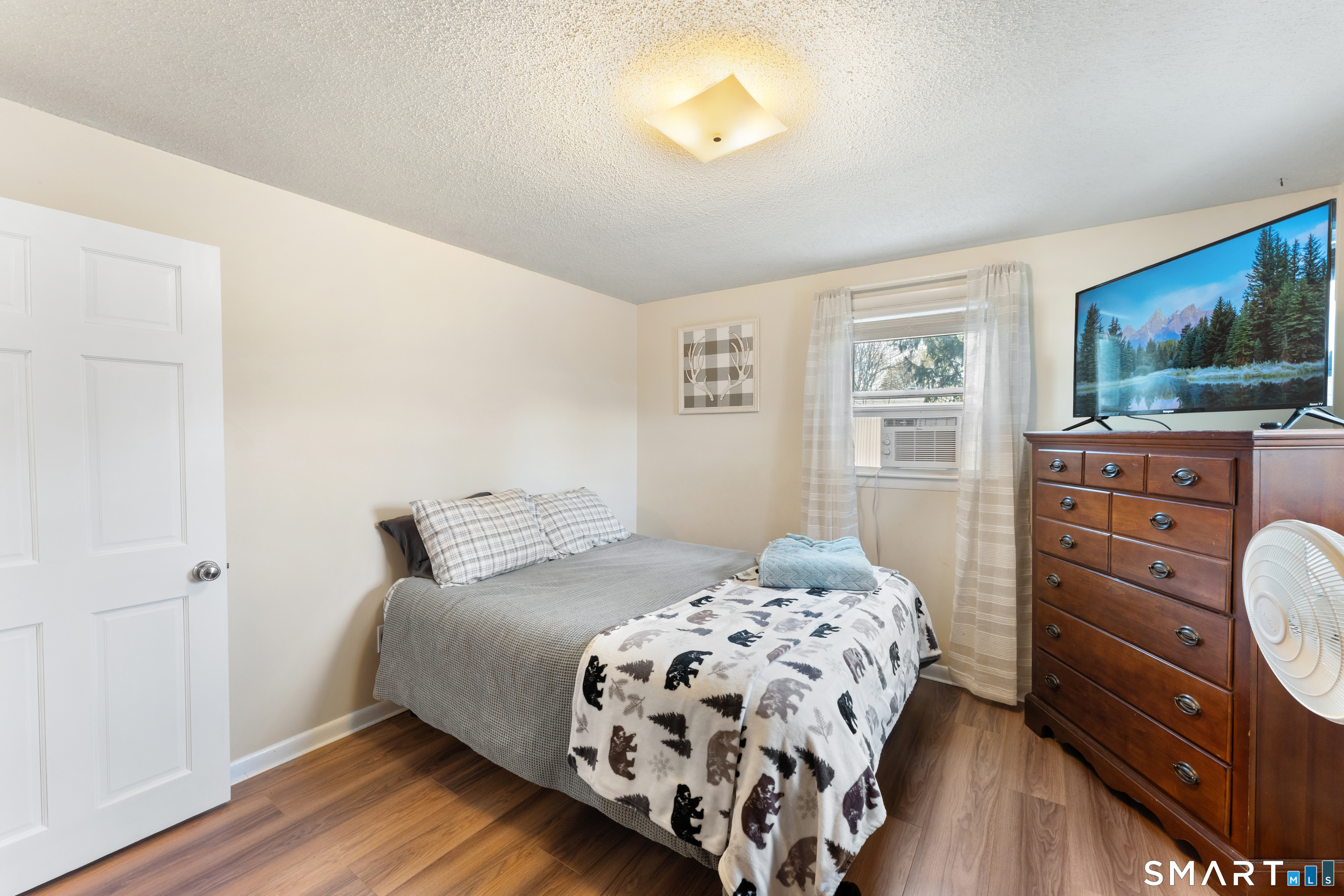 14 Liberty Lane Thompson, CT 06277 - Photo 32 of 39 a bedroom with a bed and wooden floor