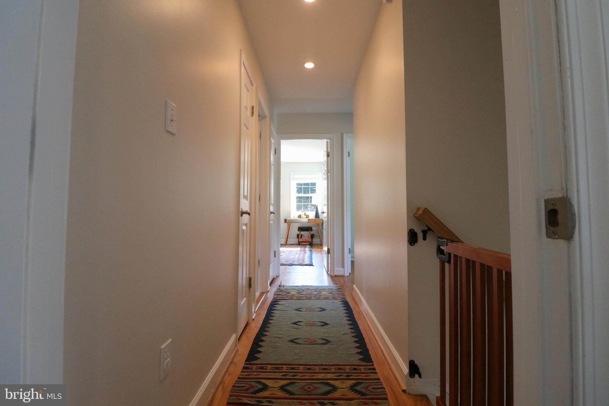 9320 Winbourne Road Burke, VA 22015 - Photo 31 of 55 Upstairs hallway with hardwoods and neutral paint.