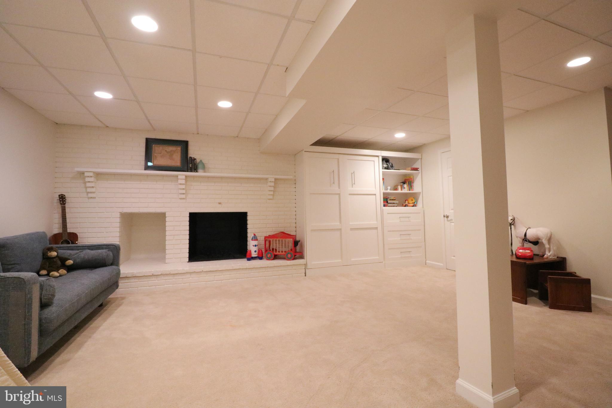 9320 Winbourne Road Burke, VA 22015 - Photo 41 of 55 Wood burning fireplace and inset lighting.