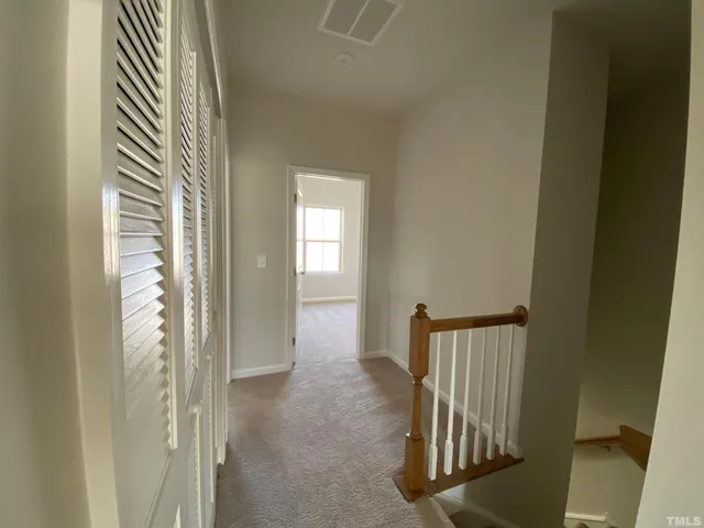 a view of a hallway with windows