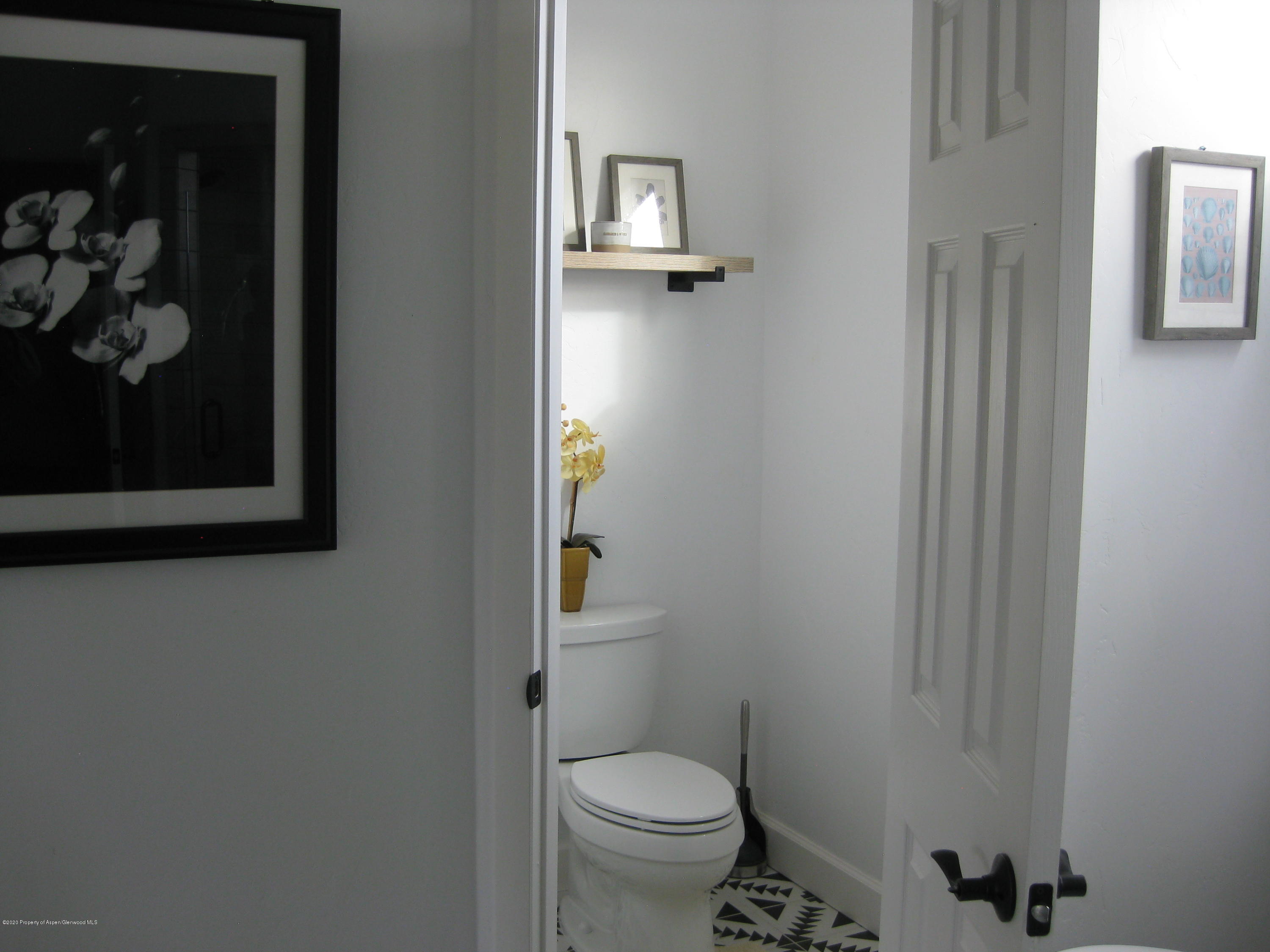 302 West 33rd Street Rifle, CO 81650 - Photo 21 of 24 a white toilet sitting next to a bathroom sink