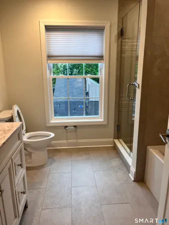a bathroom with a toilet and a shower