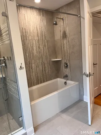 a bathroom with a bathtub and shower