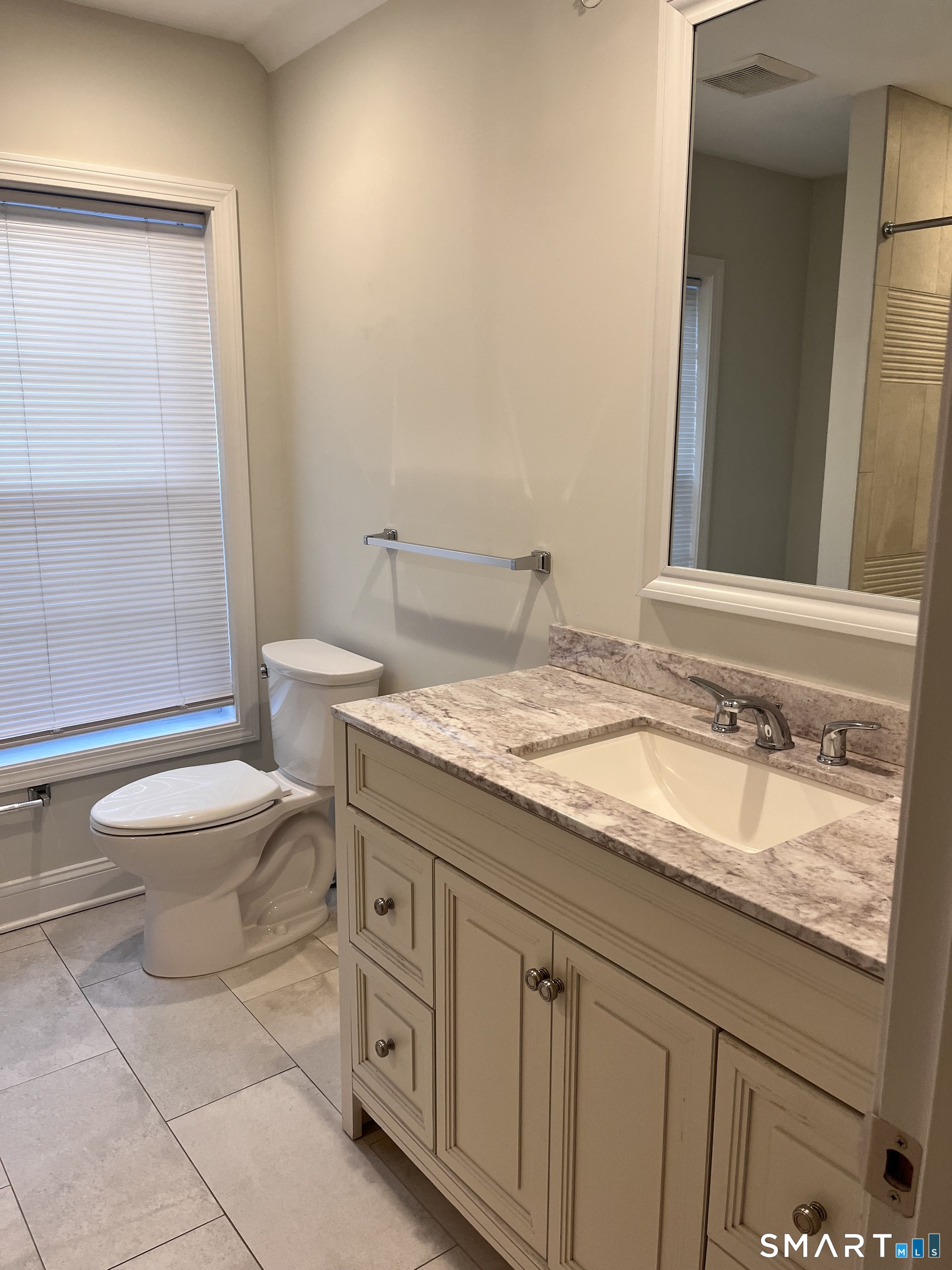 20 3rd Street, Unit 18 Stamford, CT 06905 - Photo 23 of 28 a bathroom with a granite countertop toilet sink and mirror