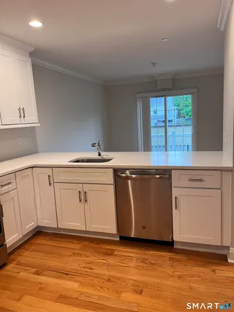 a view of a kitchen with wooden floor