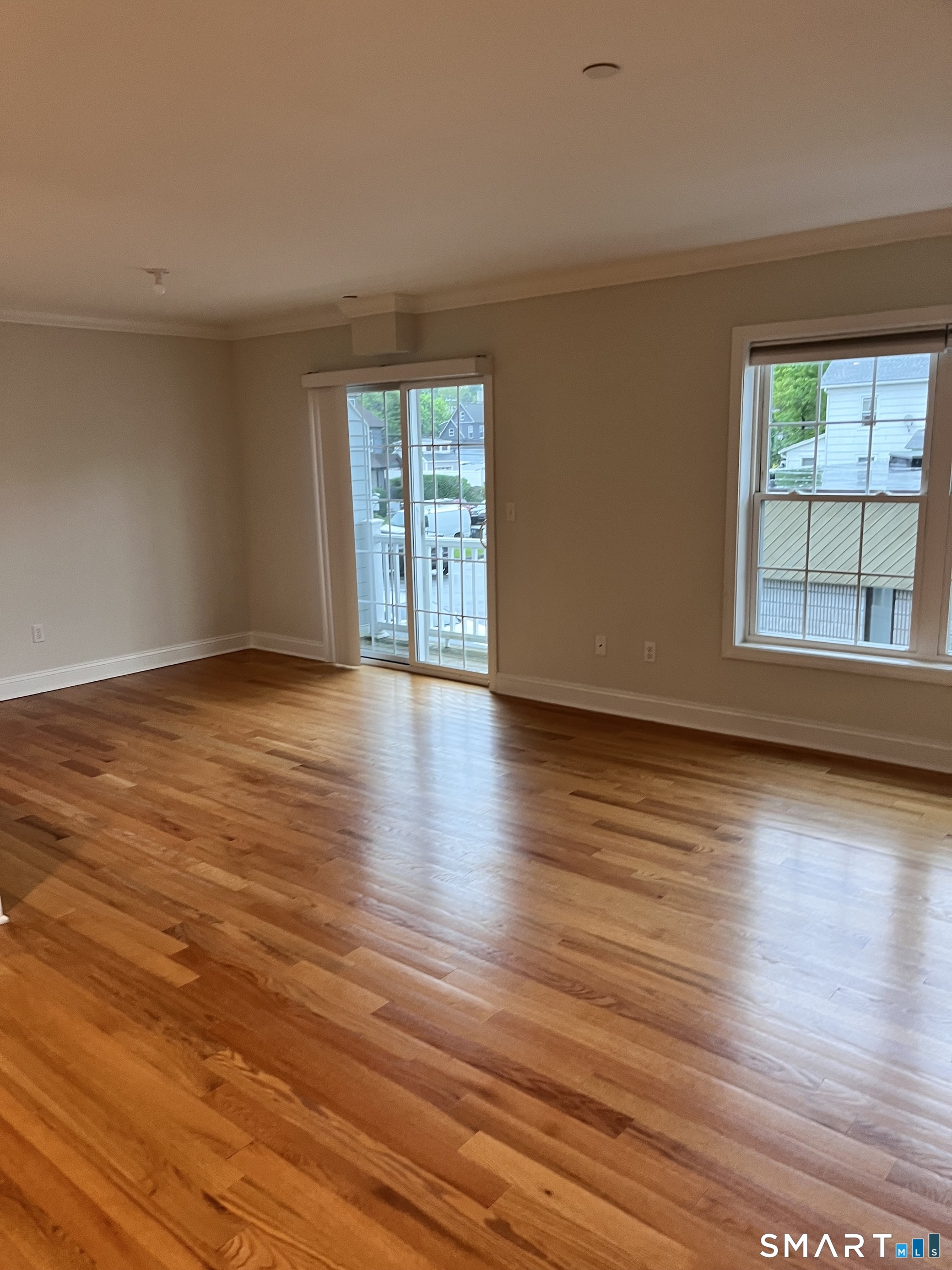 20 3rd Street, Unit 18 Stamford, CT 06905 - Photo 9 of 28 a view of an empty room with wooden floor and a window
