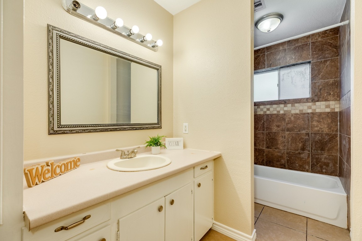 114 Singleton Street Jones Creek, TX 77541 - Photo 25 of 25 a bathroom with a sink a tub and a mirror