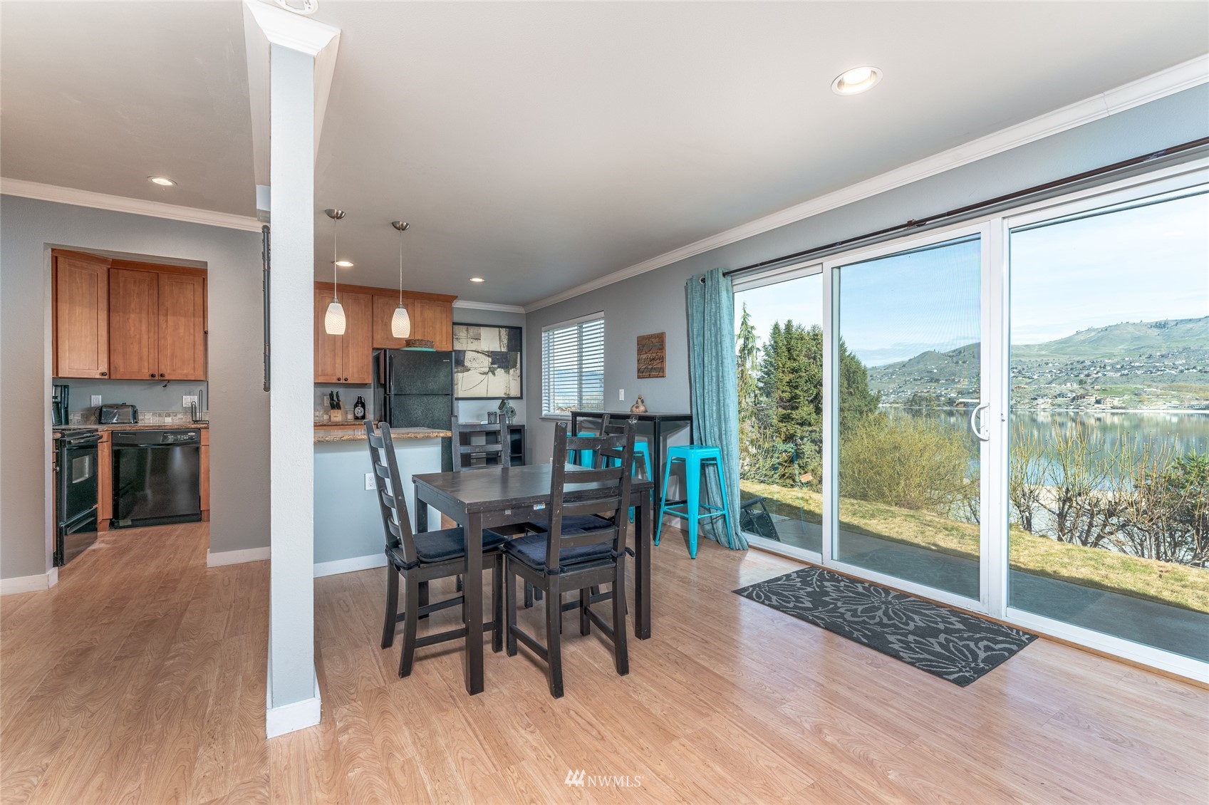 1902 West Prospect Street, Unit 112 Chelan, WA 98816 - Photo 12 of 40 a view of a dining room with furniture window and wooden floor
