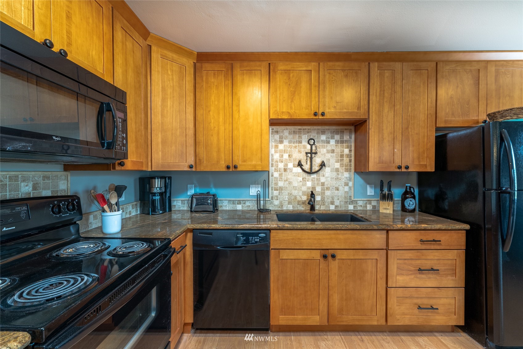 1902 West Prospect Street, Unit 112 Chelan, WA 98816 - Photo 15 of 40 a kitchen with stainless steel appliances granite countertop a stove a sink dishwasher and a refrigerator