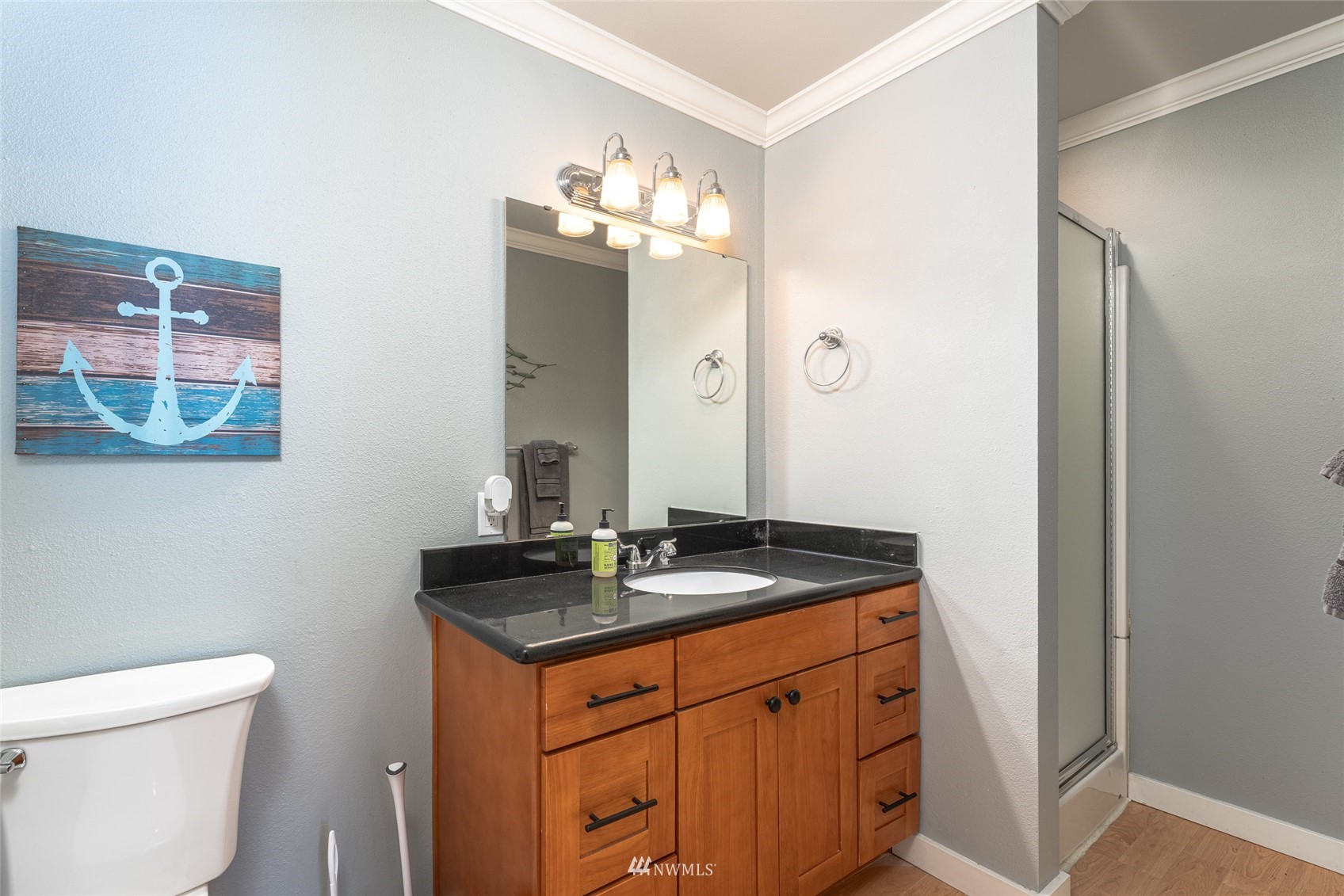 1902 West Prospect Street, Unit 112 Chelan, WA 98816 - Photo 20 of 40 a bathroom with a granite countertop sink a toilet and a mirror
