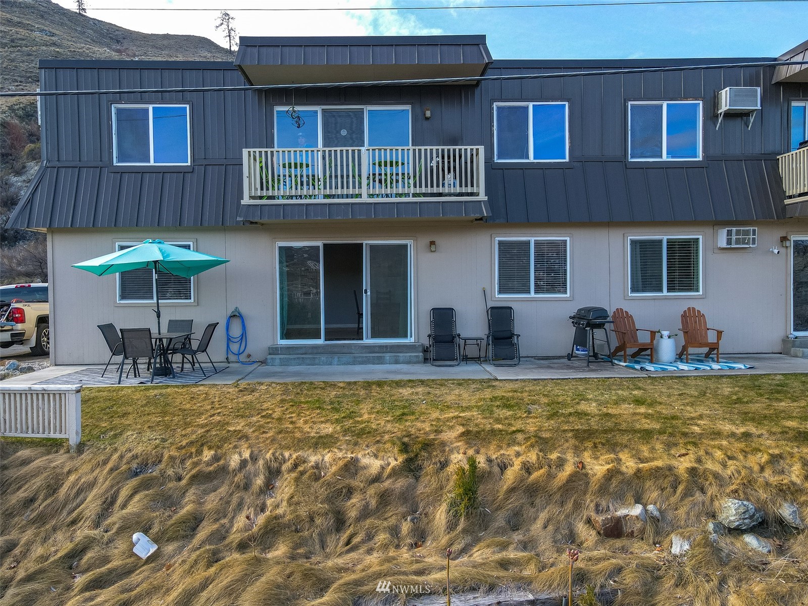 1902 West Prospect Street, Unit 112 Chelan, WA 98816 - Photo 2 of 40 a view of a house with swimming pool and furniture