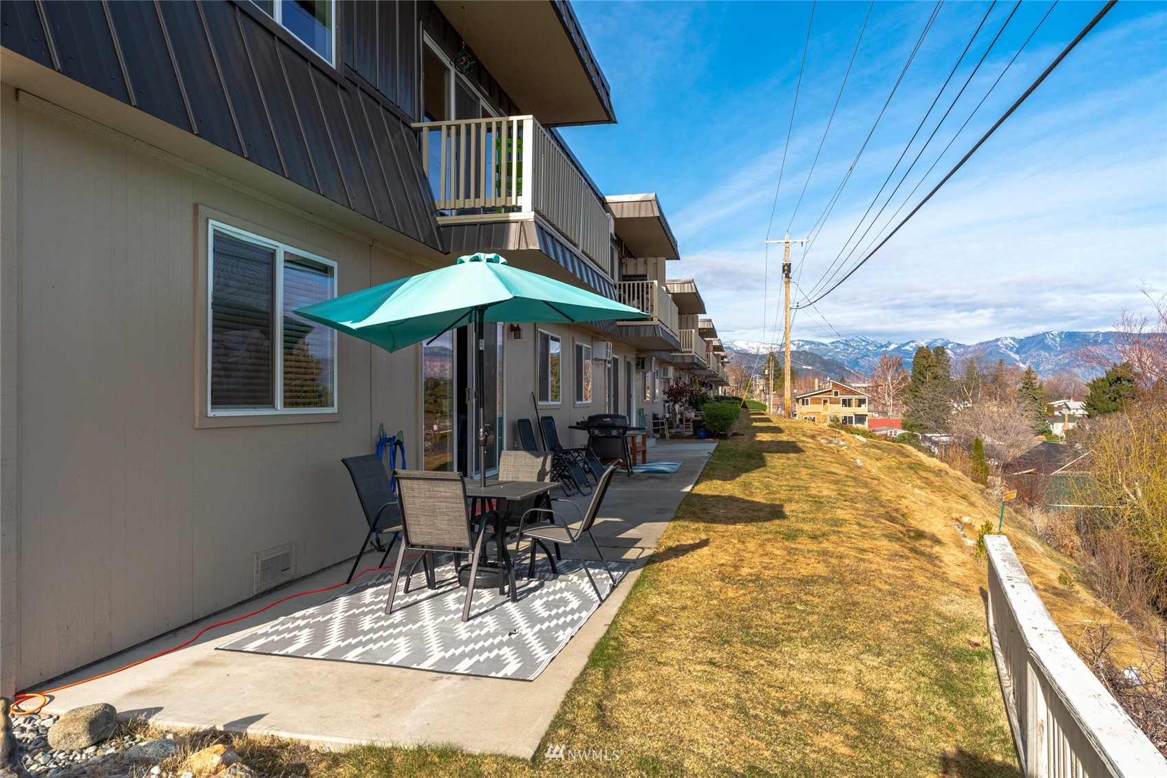 1902 West Prospect Street, Unit 112 Chelan, WA 98816 - Photo 27 of 40 a view of a patio with a table chairs and backyard
