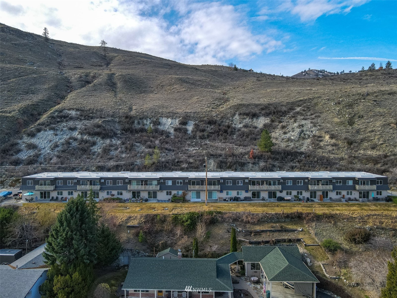 1902 West Prospect Street, Unit 112 Chelan, WA 98816 - Photo 7 of 40 a view of a swimming pool with a yard and mountain view