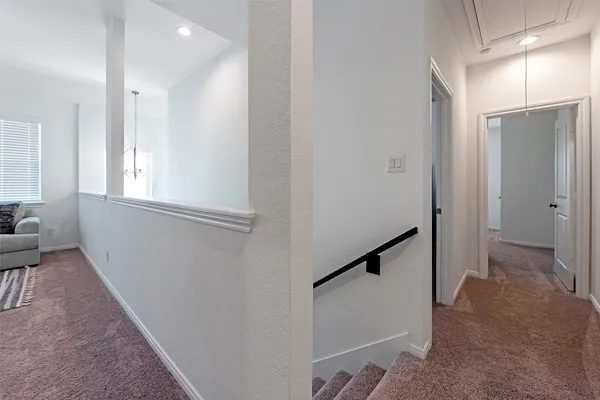 a view of hallway with windows and stairs