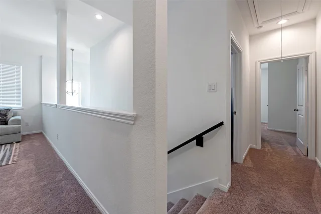 a view of hallway with windows and stairs