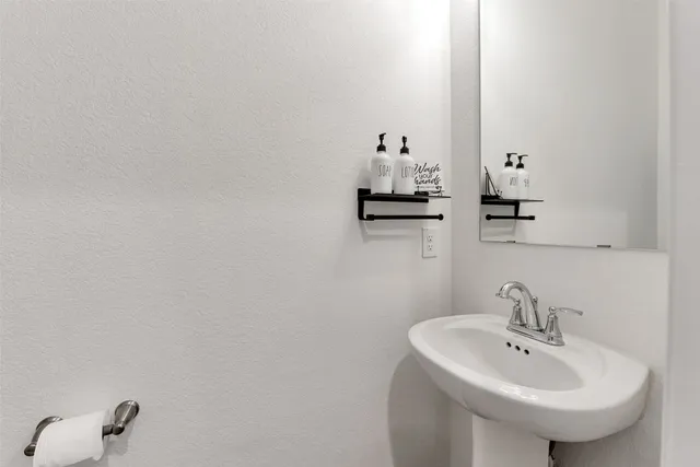 a bathroom with a sink and mirror