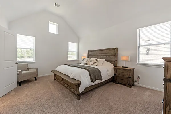 a bed sitting in a bedroom next to a window