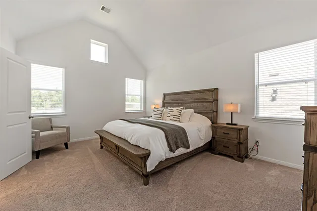 a bed sitting in a bedroom next to a window