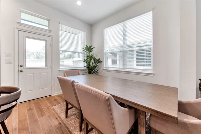 a dining room with furniture and window