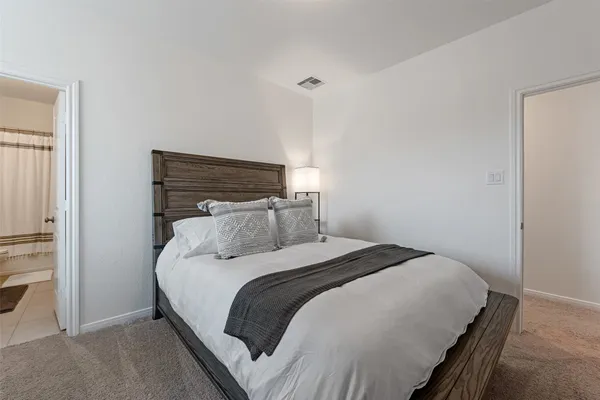 a bedroom with a bed and a ceiling fan