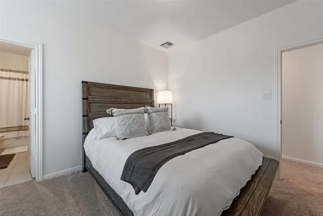 a bedroom with a bed and a ceiling fan