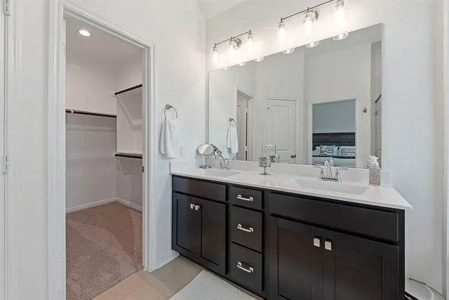 a bathroom with a double vanity sink mirror and double