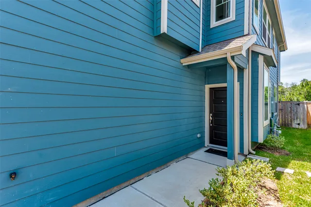 a view of a wooden door and brick wall