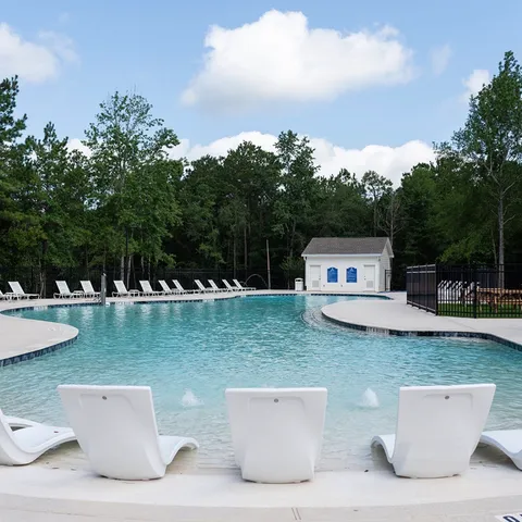 a view of a house with pool porch and chairs